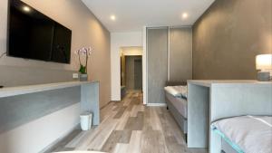 a room with two beds and a flat screen tv at VOK Pension in Neunkirchen am Sand