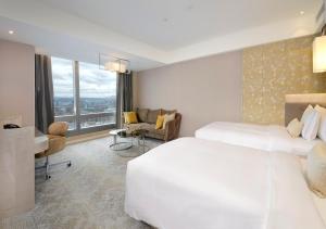 Letto o letti in una camera di Caesar Park Hotel Banqiao