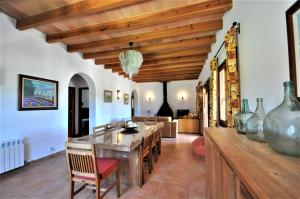 a living room with a wooden ceiling and a table at CAS BORRASSOS- Finca con piscina privada y Vistas Despejadas in Palma de Mallorca