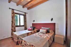a bedroom with two beds and a window at CAS BORRASSOS- Finca con piscina privada y Vistas Despejadas in Palma de Mallorca