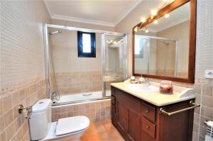 a bathroom with a toilet and a sink and a shower at CAS BORRASSOS- Finca con piscina privada y Vistas Despejadas in Palma de Mallorca +34 photos