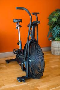 a exercise bike parked in a room with an orange wall at Motel L Hammarby Sjöstad in Stockholm