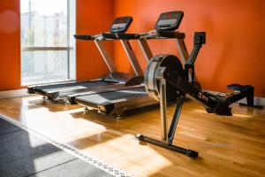 a treadmill in a room with an orange wall at Motel L Hammarby Sjöstad in Stockholm