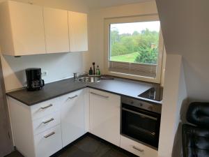 a small kitchen with a sink and a window at Poseidon in Nebel