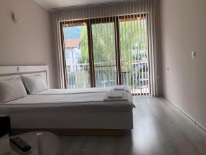 a bedroom with a bed and a large window at Guest House Rest in Sapareva Banya