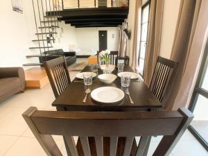 a wooden table with chairs and a dining room at Colonial9 Suite (Sunrise & Mountain View)@Empire City in Petaling Jaya
