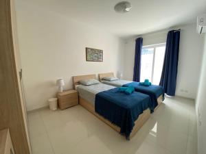 A bed or beds in a room at Sunshine Apartments Mellieha - modern three bedroom apartment - Apt No 1