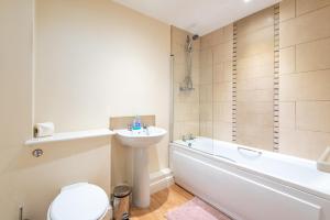 a bathroom with a sink and a toilet and a bath tub at Apartment 11 in Worksop