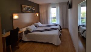 Ένα ή περισσότερα κρεβάτια σε δωμάτιο στο Hotel Villa de los Arcos