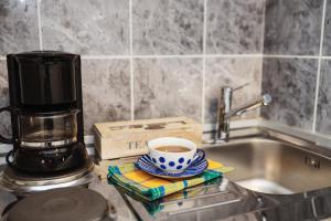 a cup of coffee sitting on top of a kitchen counter at City Center Studio in Belgrade +62 photos