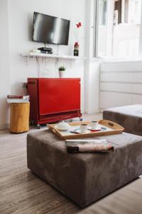 a living room with a ottoman with bowls on it at City Center Studio in Belgrade