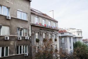 an apartment building with flags on top of it at City Center Studio in Belgrade