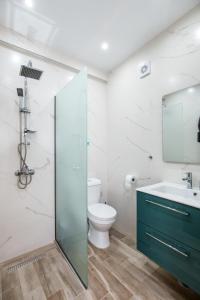 a bathroom with a toilet and a sink at Doukas Apartments Luxury Living in Skala Marion