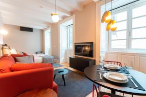 a living room with a couch and a table at FLH Viola Market Studios in Funchal