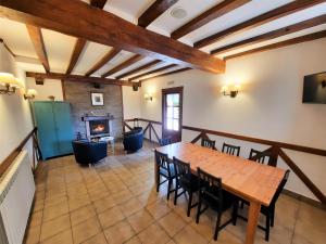 a dining room with a table and a fireplace at Casa Rural Iruso in Leitza