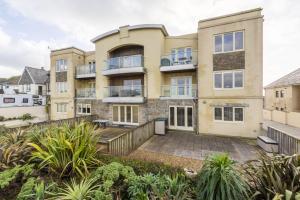 an apartment building with a patio and plants at 5 The Vista, Newquay in Newquay