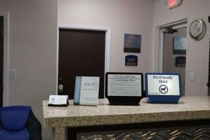 a counter with two boxes and a tablet on it at Best Western Lake Conroe in Montgomery