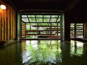 a room with a pool of water in front of a window at Kutsurogijyuku Shintaki in Aizuwakamatsu