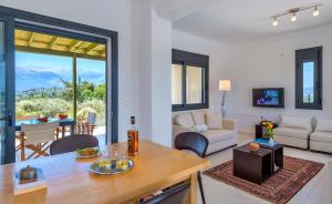 a living room with a table and a couch at Villa Lefki in Vamos