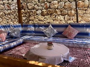 a table with pillows sitting on top of a couch at Ambar Evleri in Kalkan
