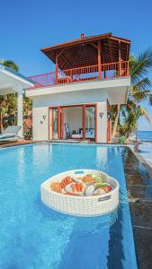 a pool with a bowl of food in the middle of a house at Air Sanih Beach Villa in Kubutambahan