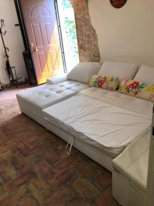 a large bed sitting in a room with a door at Casavacanze Ciaspole E Uva in Fiastra