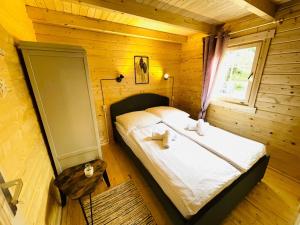 a bedroom with a bed in a wooden room at Inselglück Usedom in Kamminke