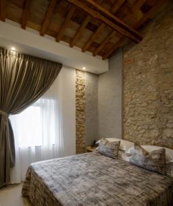 a bedroom with a large bed and a large window at Tenuta Sovestro in San Gimignano