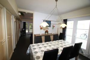 a dining room with a table and chairs in a room at Park Atlantis De Haan Klemskerke in De Haan