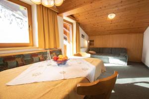 a room with a table with a bowl of fruit on it at Appartement zum Schatzberg WILD021 in Auffach
