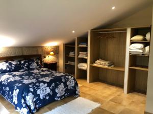 a bedroom with a blue and white bed and shelves at Villa Casa de Campo Los Carballos in Tomiño +56 photos