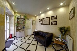 a living room with a couch and a tiled floor at Hotel Svetlitsa in Vologda