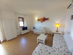 un soggiorno con divano e tavolo di WHITE LOTUS Apartment a Taormina