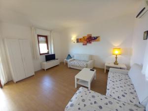 a living room with a couch and a table at WHITE LOTUS Apartment in Taormina