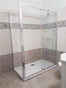 a shower with a glass door in a bathroom at Cozy holyday apartament in Paralimni