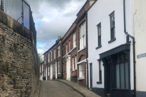 an alley with buildings on the side of a street at Market Square Grade II Listed Apartment in Macclesfield