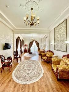 a large living room with a chandelier and a couch at Старый Бастион in Bender