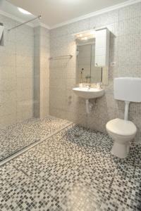 a bathroom with a toilet and a sink at Villa Paradiso By Italy in Mostar +56 photos