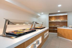 a buffet line with many different types of food at Olé Tropical Tenerife Adults Only in Playa de las Americas
