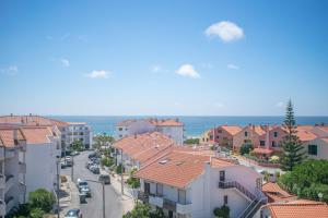 an aerial view of a town with buildings and the ocean at Areia da Consolação in Consolacao