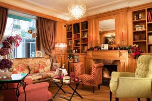 a living room with a couch and a fireplace at Hôtel Cordelia Opéra-Madeleine in Paris