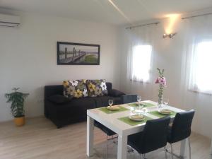 a living room with a table and a couch at Apartments Levanat in Zadar