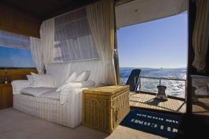 a living room with a white couch and a balcony at Motor Boat Paloma Rea in Trogir