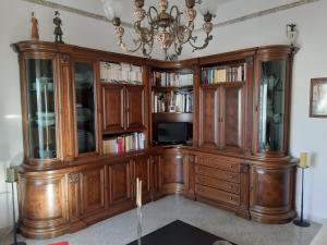 a large wooden entertainment center with a tv in it at Jarubed in Alberobello