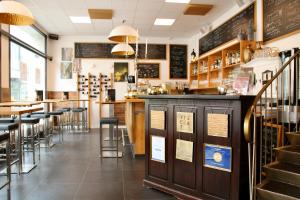 a restaurant with a bar and some chairs and tables at L'Ostello Altstadthotel in Regensburg