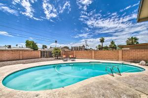 a swimming pool in a yard with a brick wall at Stylish and Central Mesa Home with Private Pool! in Mesa