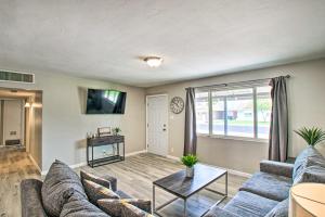 a living room with a couch and a table at Stylish and Central Mesa Home with Private Pool! in Mesa