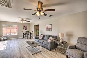 a living room with a couch and a ceiling fan at Stylish and Central Mesa Home with Private Pool! in Mesa