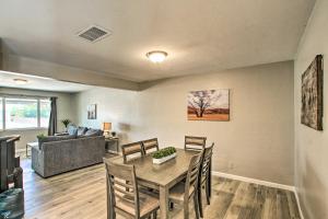 a dining room with a table and chairs and a couch at Stylish and Central Mesa Home with Private Pool! in Mesa