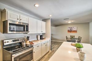 a kitchen with white cabinets and a stove top oven at Stylish and Central Mesa Home with Private Pool! in Mesa